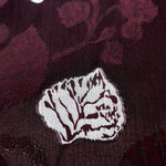 Embossed two-tone jacquard close detail for textured dress fabric.