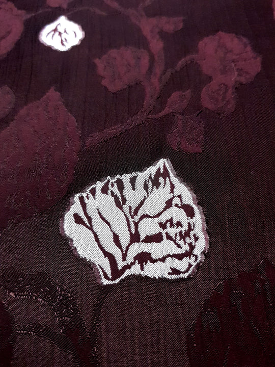 Embossed two-tone jacquard close detail for textured dress fabric.