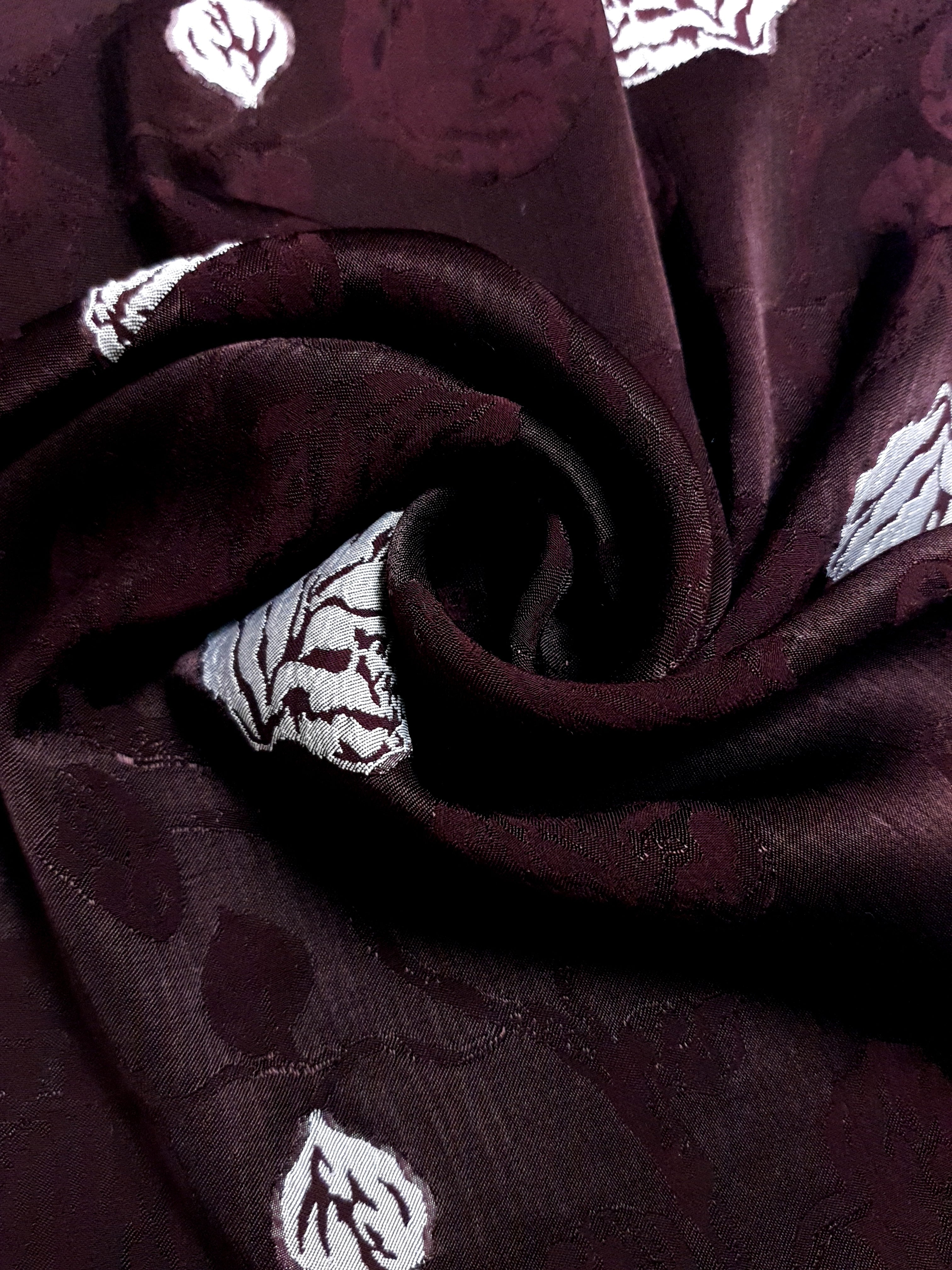 Close view of viscose jacquard with raised leaf texture for garments.