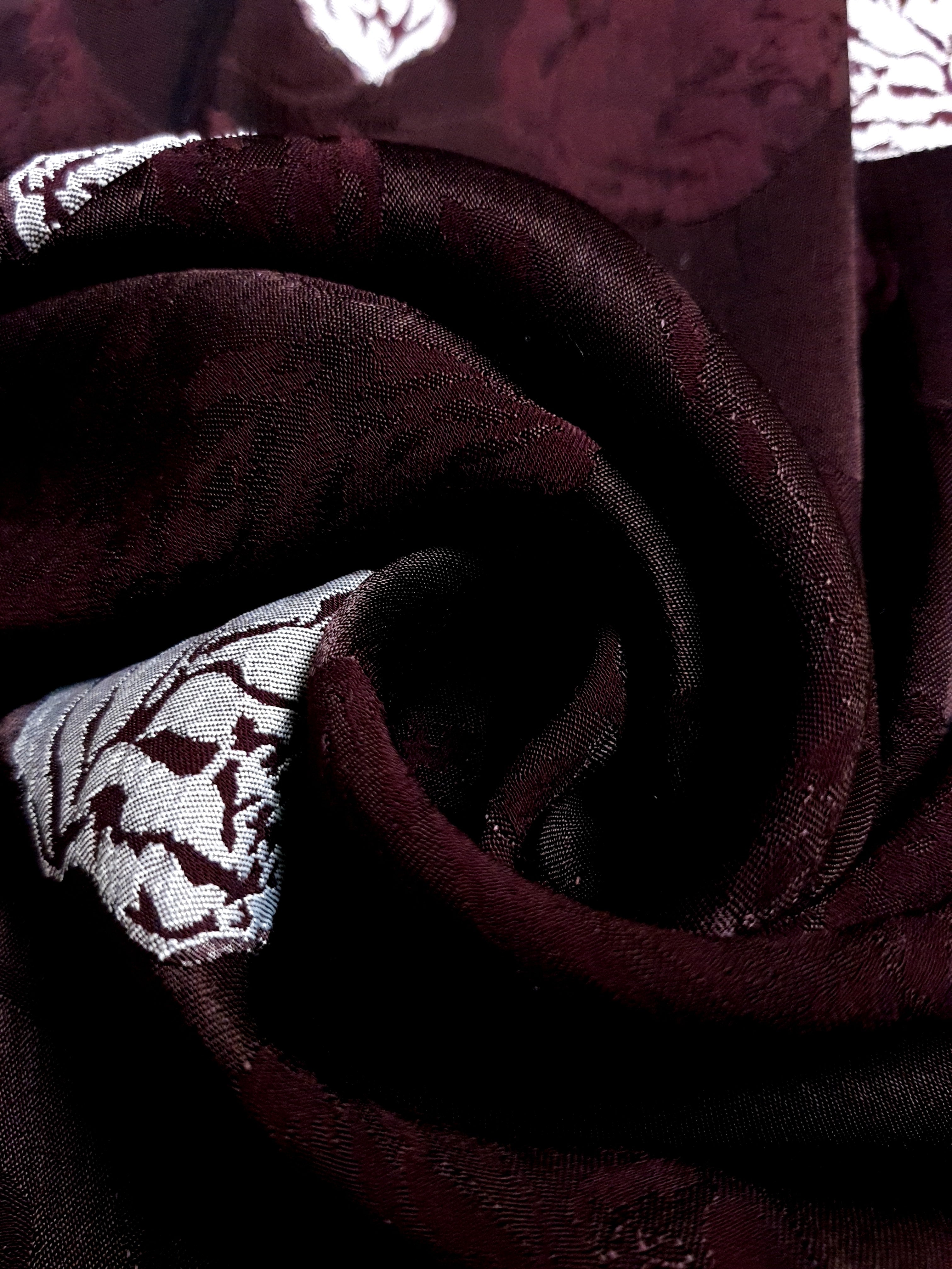 Close-up of two-tone viscose jacquard fabric with soft raised texture.
