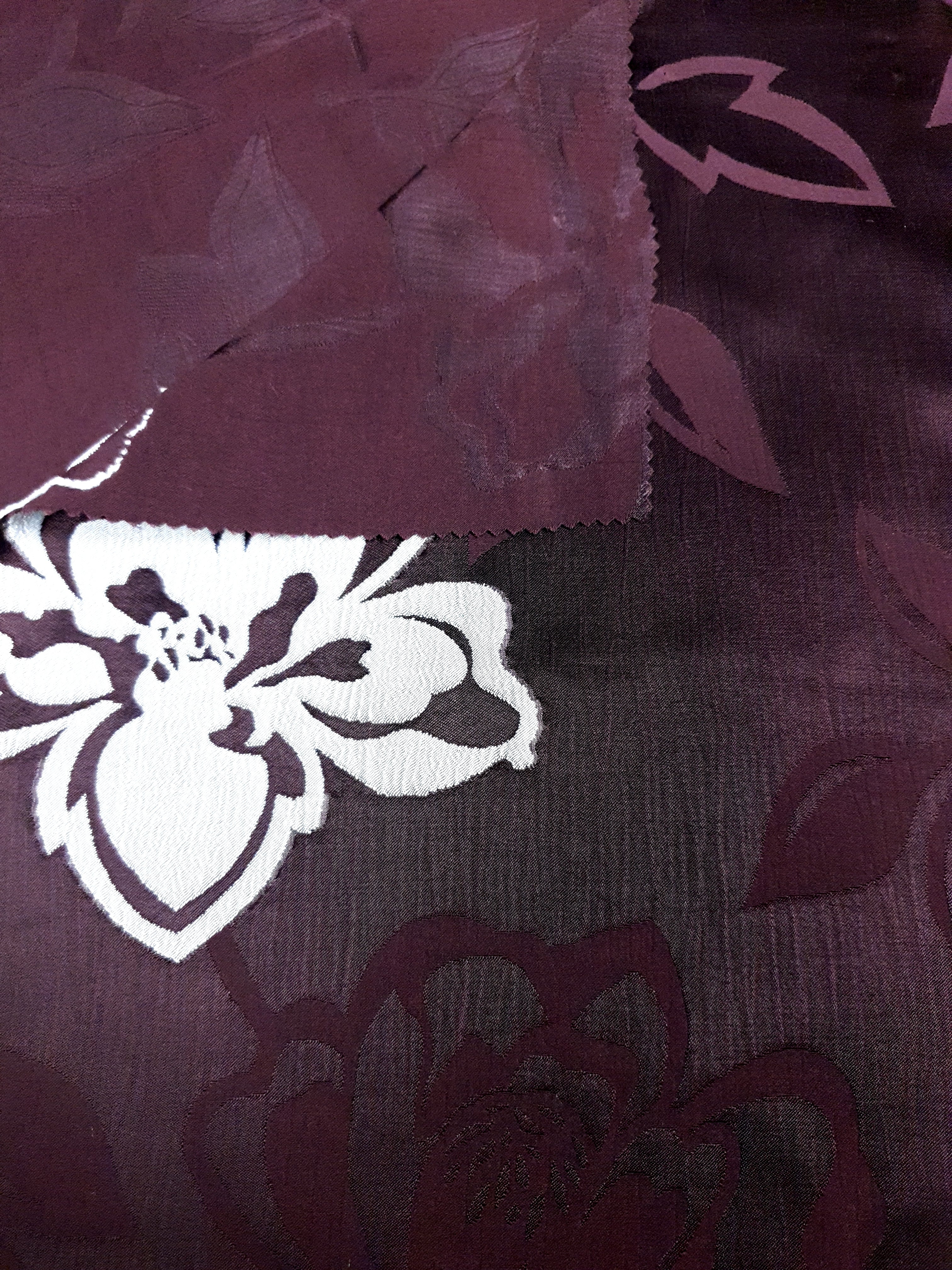 Embossed jacquard texture view for raised leaf dress fabric.