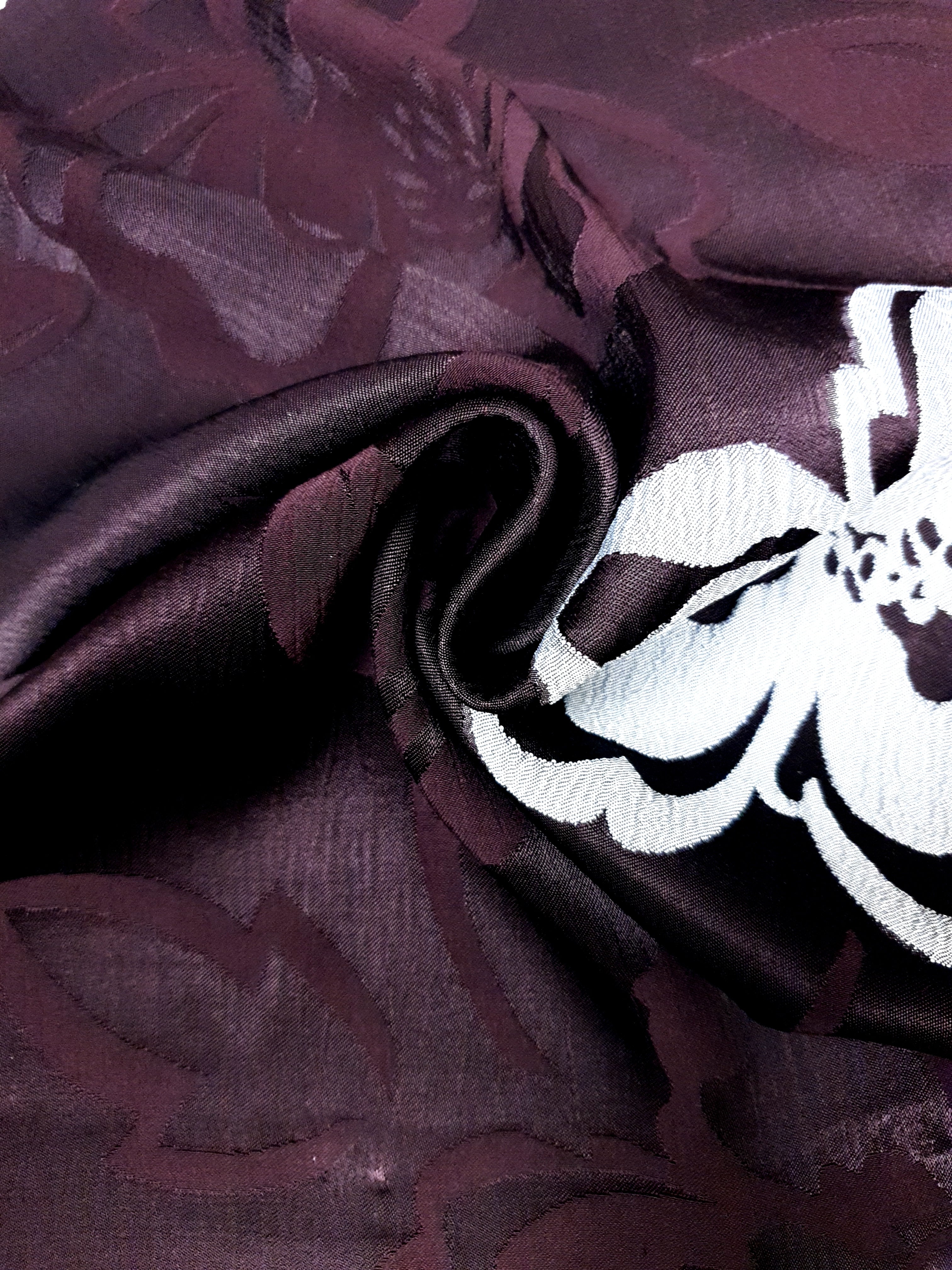 Wave and drape view of viscose jacquard showing soft garment movement.