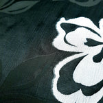 Close view of embossed jacquard fabric showing soft hand and raised motif.