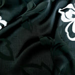 Texture detail of woven viscose jacquard with raised embossed pattern.