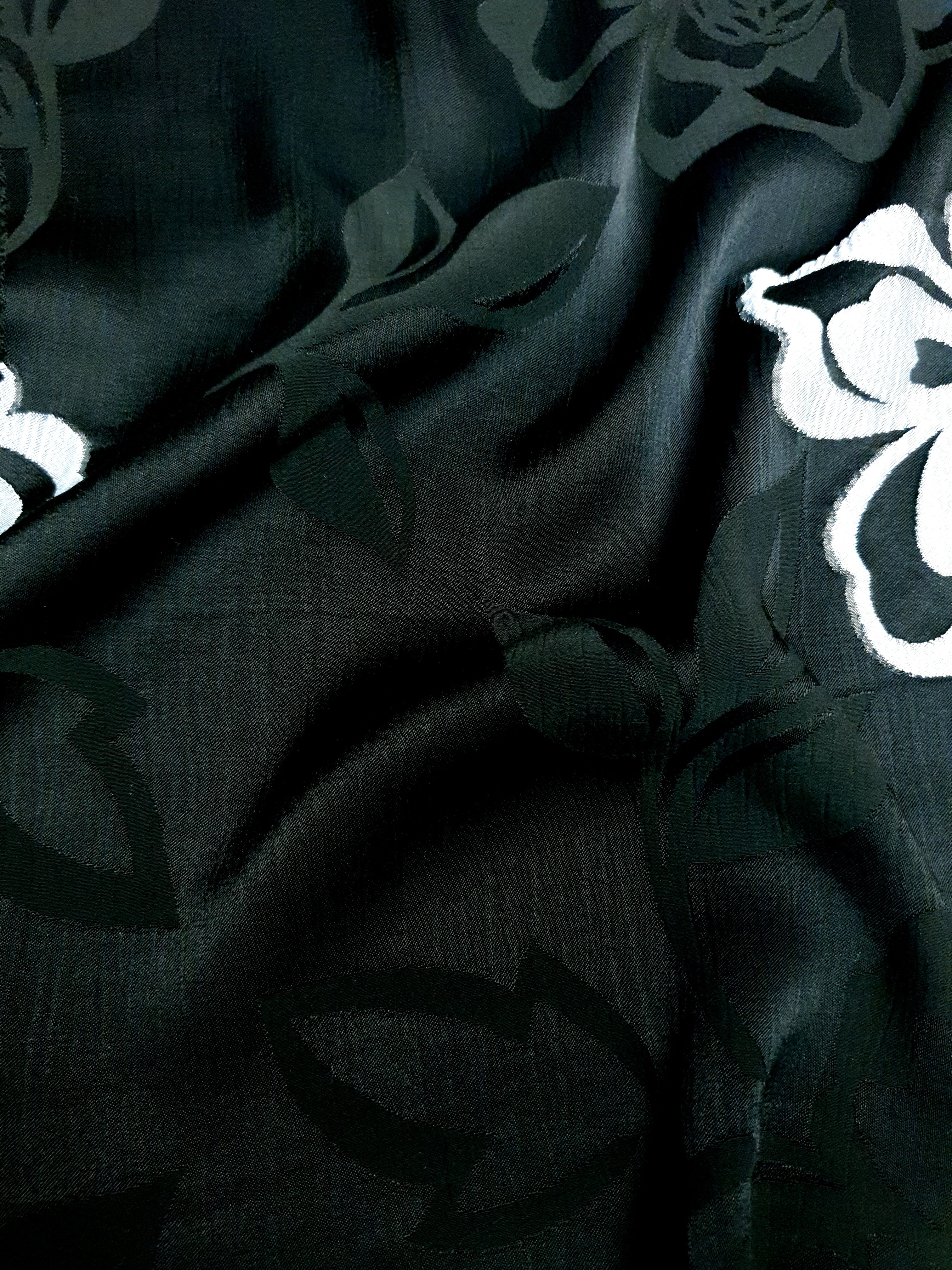 Texture detail of woven viscose jacquard with raised embossed pattern.