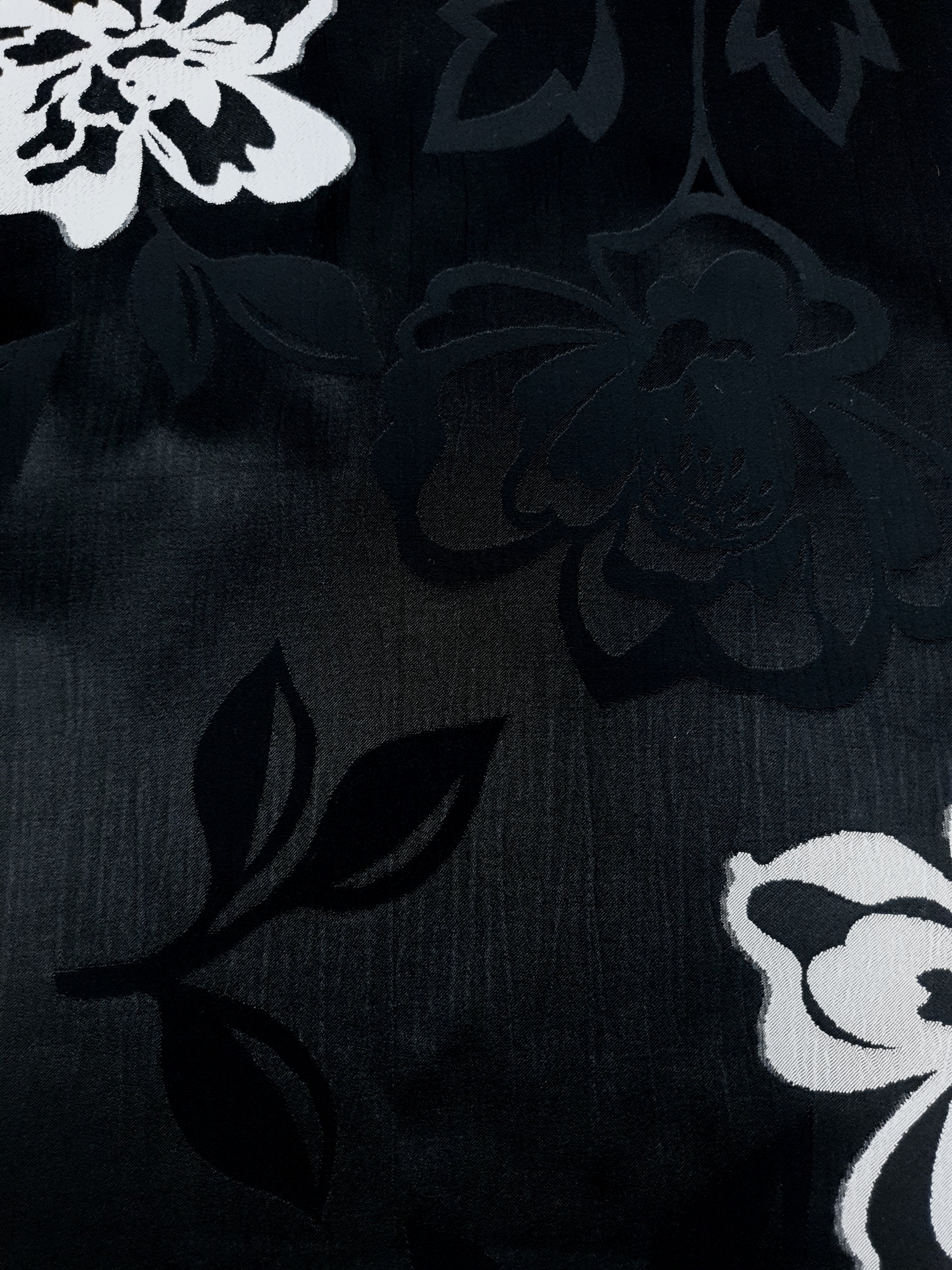Close texture of soft viscose jacquard with raised embossed detail.