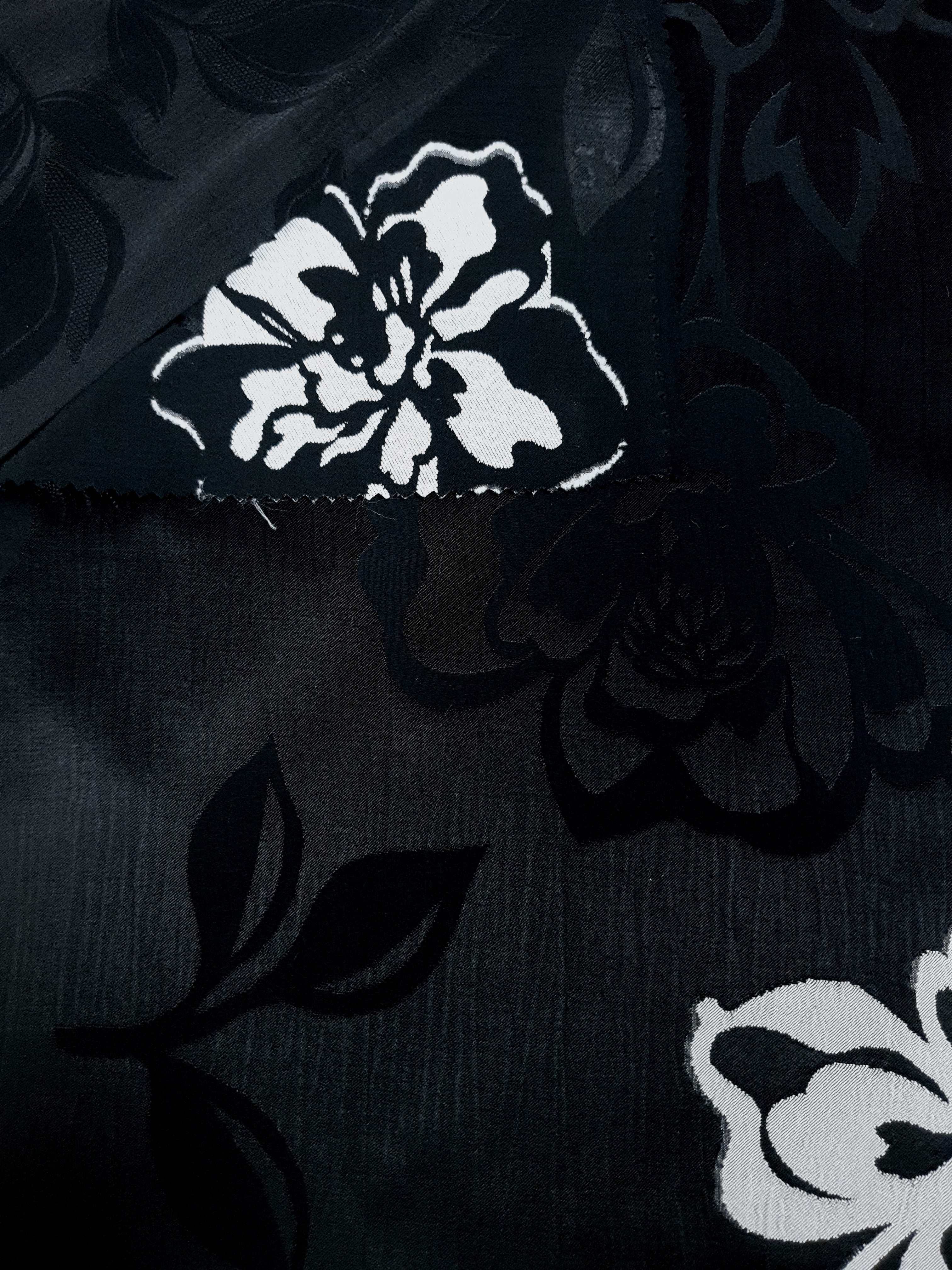 Embossed viscose jacquard design close detail for garment sewing.