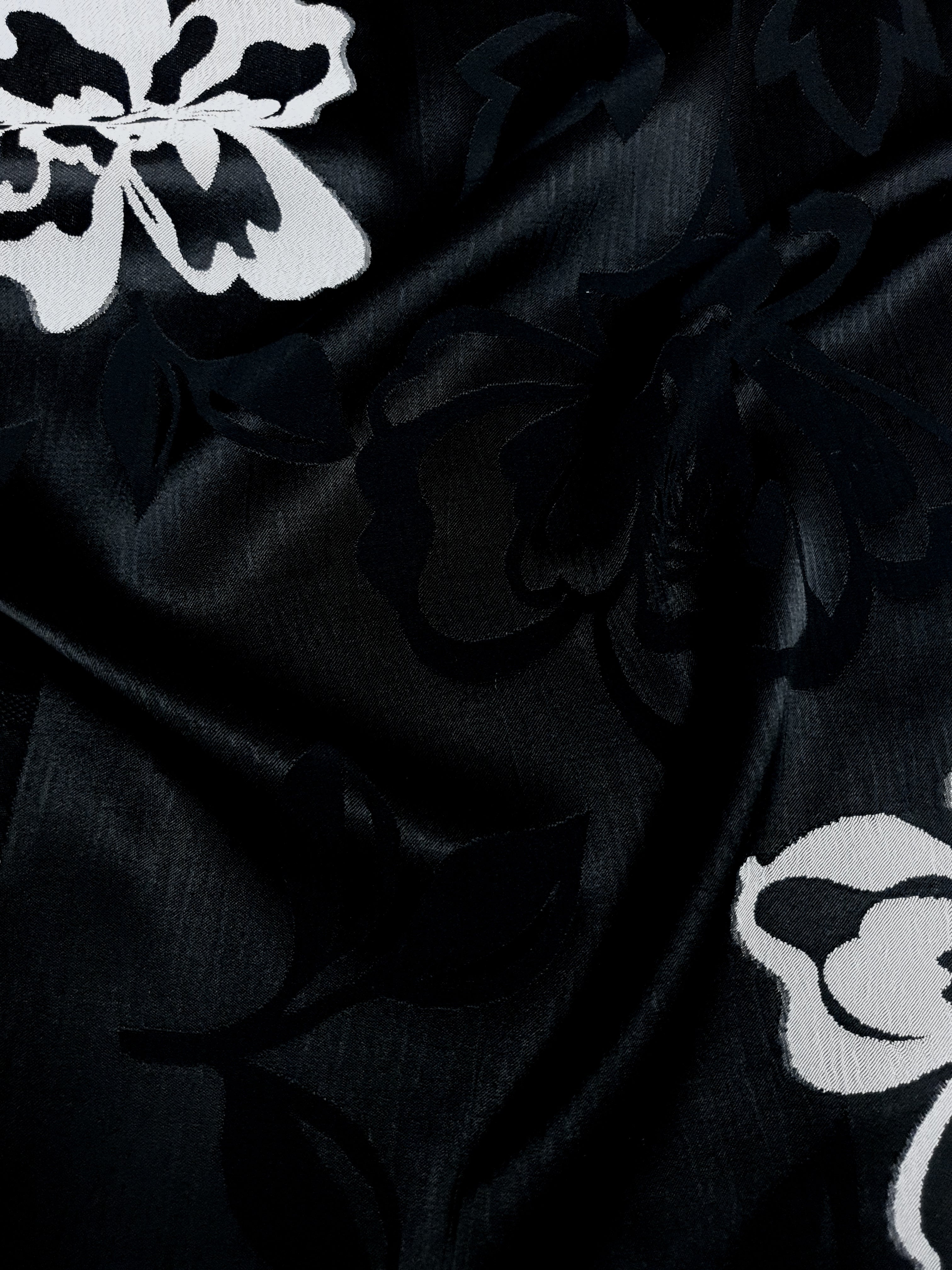 Drape detail of two-tone viscose jacquard with raised woven surface.