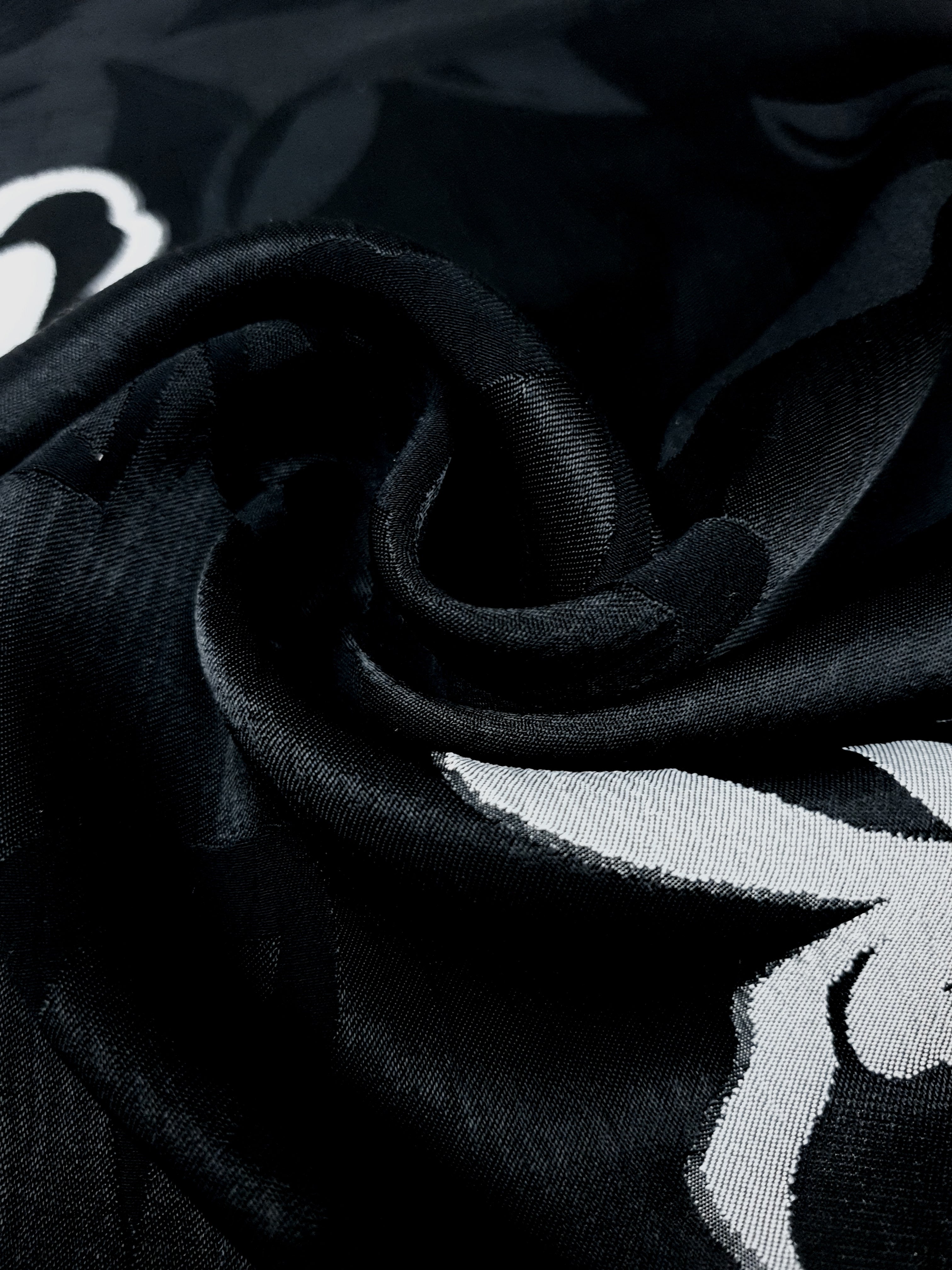 Full view of two-tone woven jacquard fabric for dressmaking.