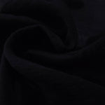 Formal black flower embossed viscose jacquard fabric closeup for sheer overlays.
