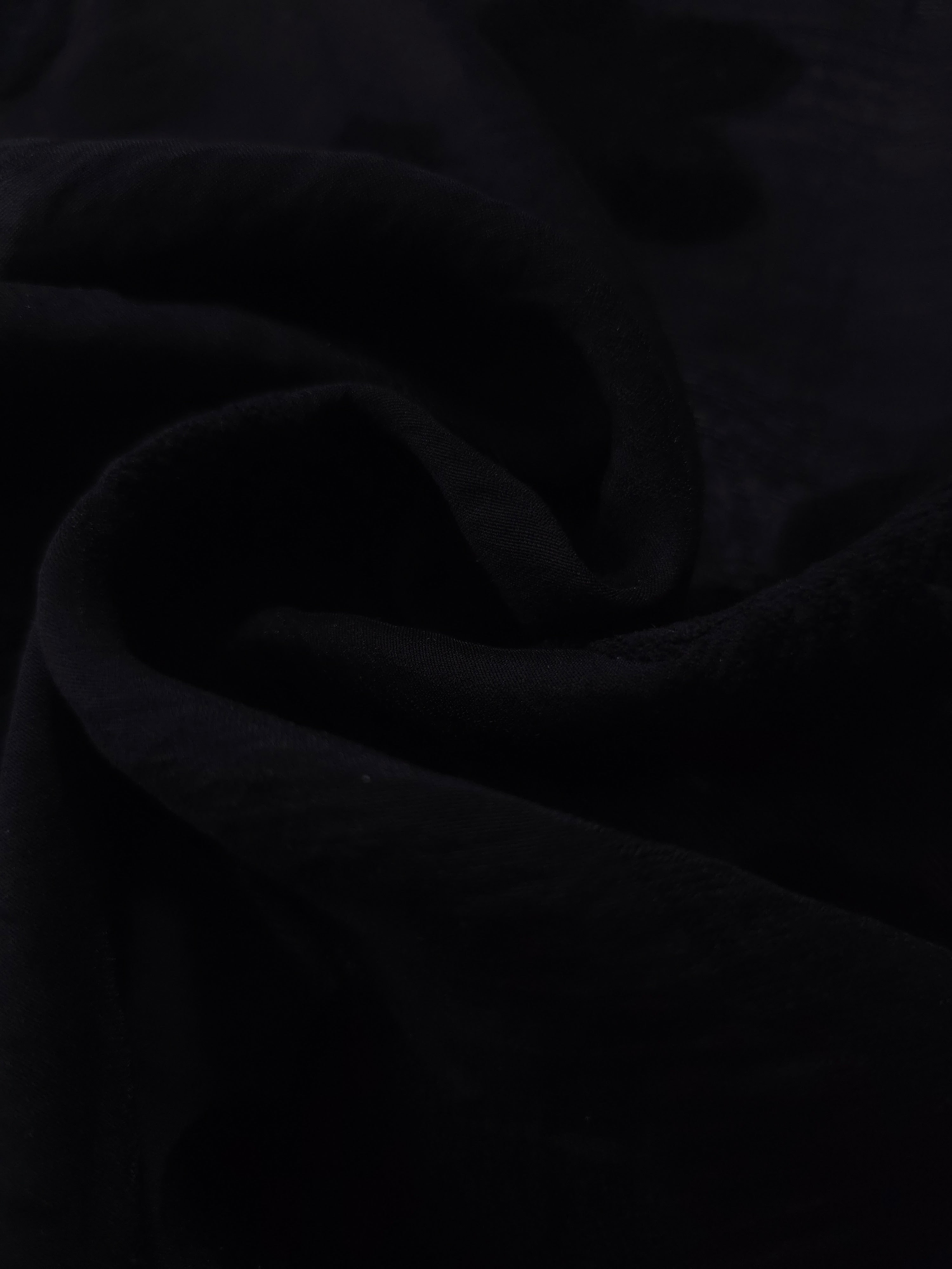 Formal black flower embossed viscose jacquard fabric closeup for sheer overlays.