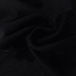 Draped texture of formal black flower embossed viscose jacquard fabric for garment layers.