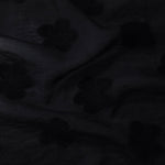 Drape view of formal black flower embossed viscose jacquard fabric for kaftan overlays.