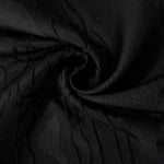 Drape view of black laurel polyester crepe jacquard fabric for dresses, skirts and jackets.