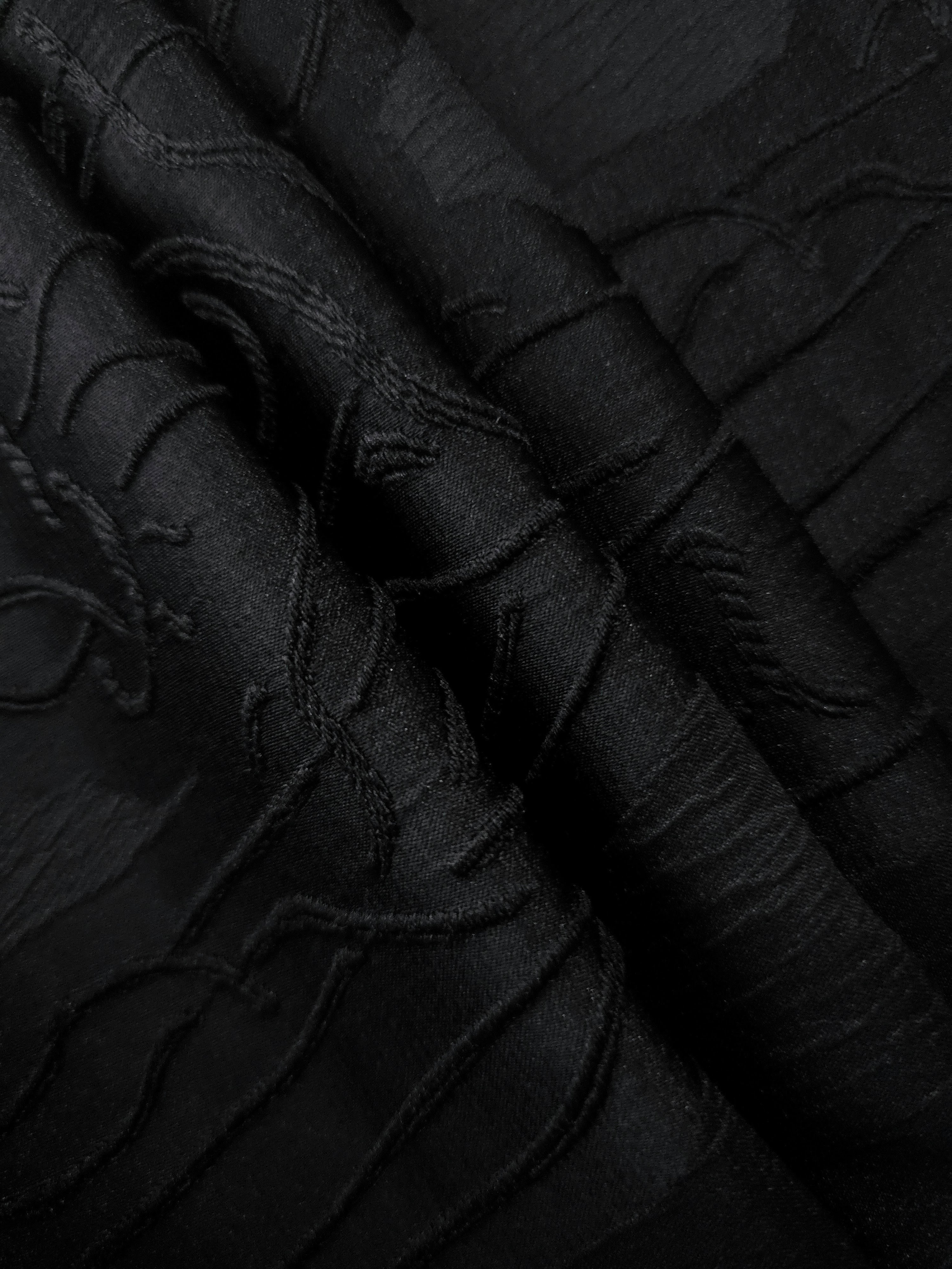 Full view of black laurel polyester crepe jacquard fabric with tonal raised texture.
