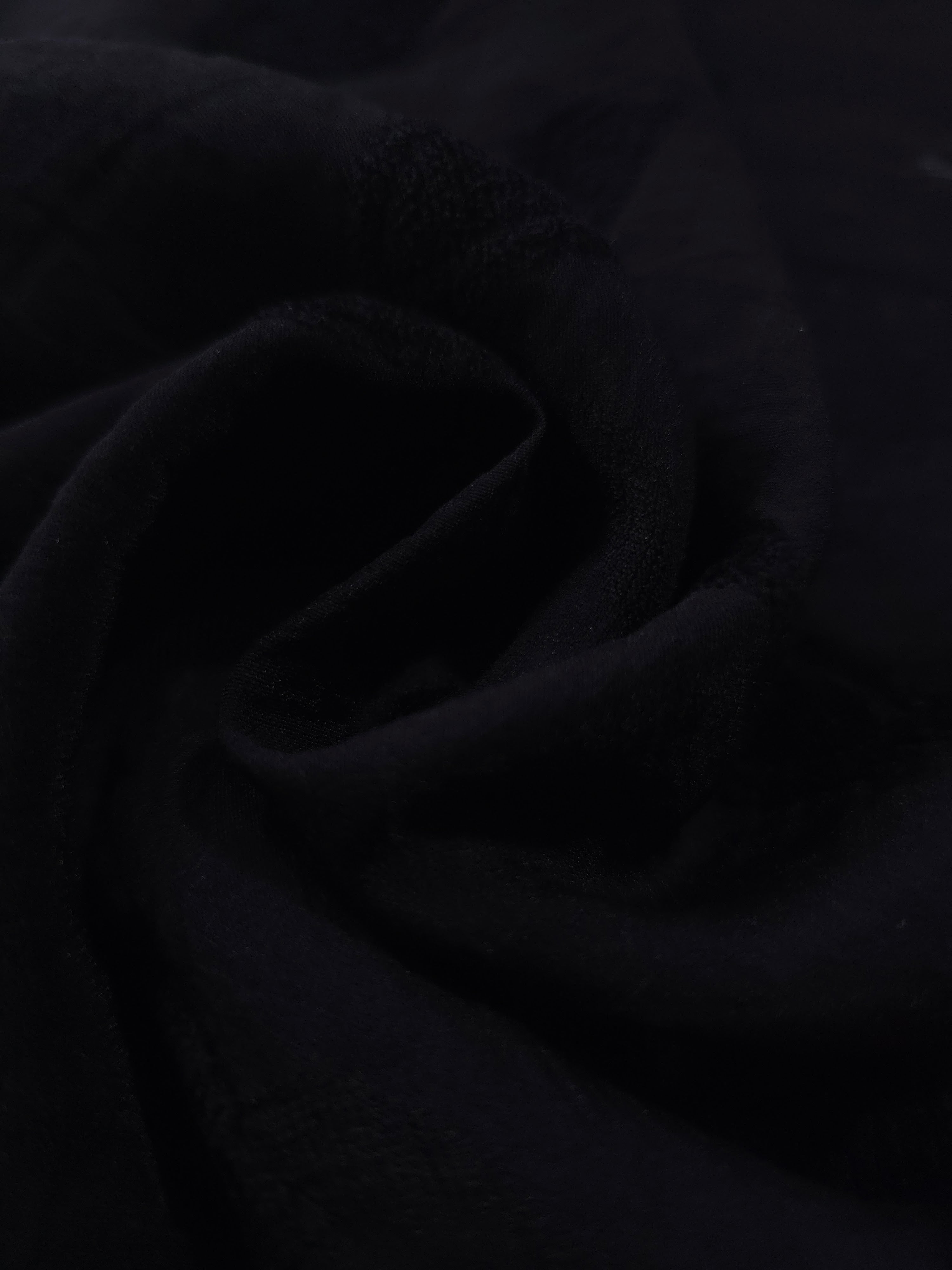 Formal black leaf embossed viscose jacquard fabric closeup for sheer overlays.