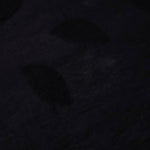 Closeup texture of formal black leaf embossed viscose jacquard fabric.