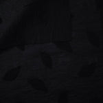 Front and back view of formal black leaf embossed viscose jacquard fabric.