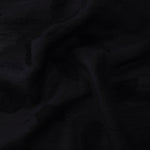 Drape view of formal black leaf embossed viscose jacquard fabric for kaftan overlays.