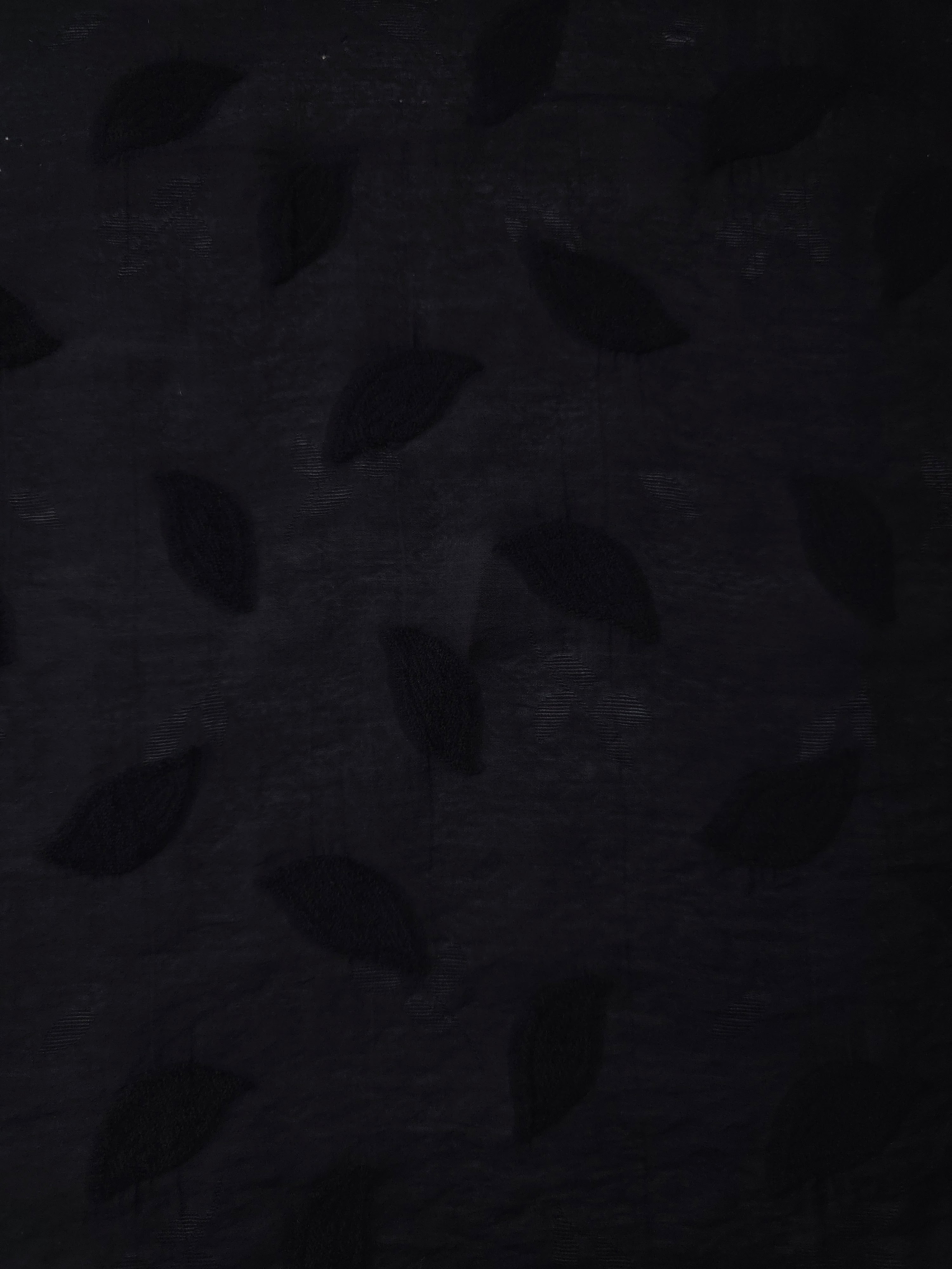 Wide view of formal black leaf embossed viscose jacquard fabric with tonal raised motif.