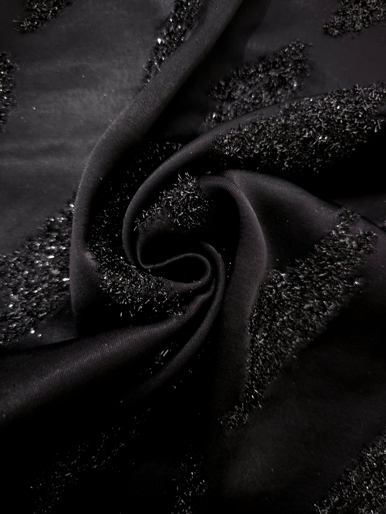 Folded Metallic Black viscose jacquard fabric with organic reflective brush marks