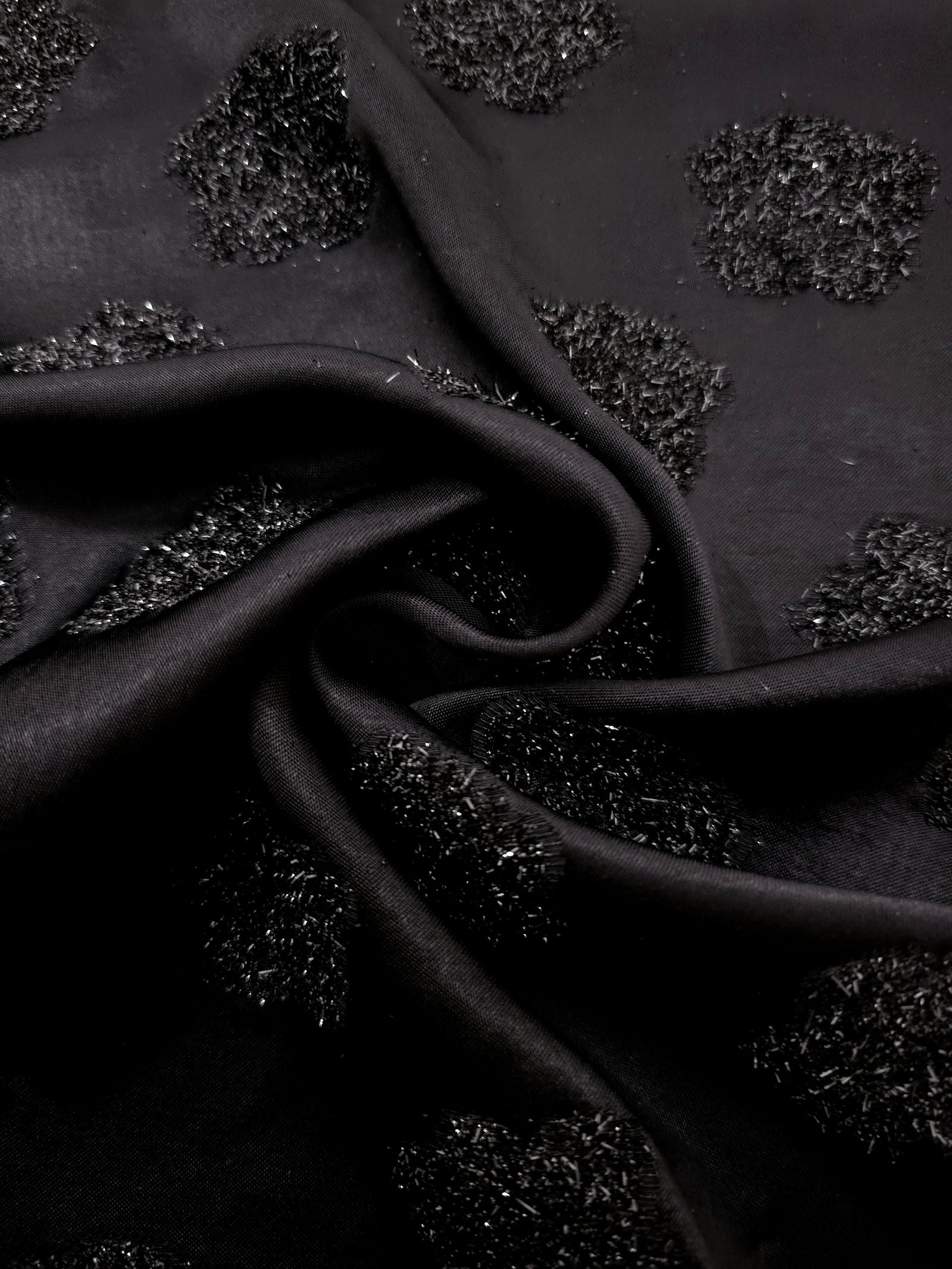 Folded Metallic Black viscose jacquard fabric with organic metallic pebble motif