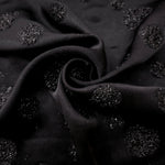 Folded Metallic Black viscose jacquard fabric featuring scattered metallic confetti dots