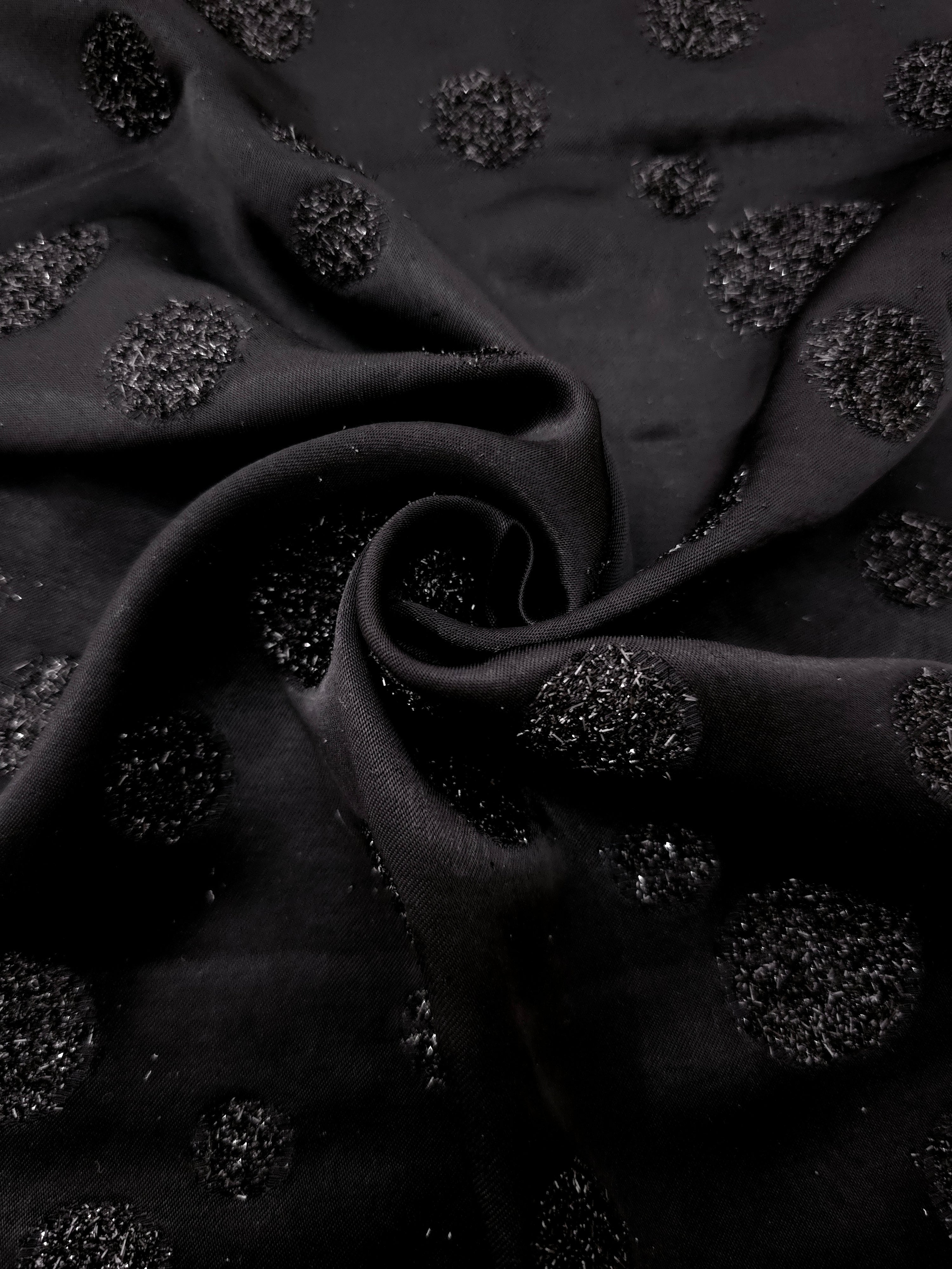 Folded Metallic Black viscose jacquard fabric featuring scattered metallic confetti dots
