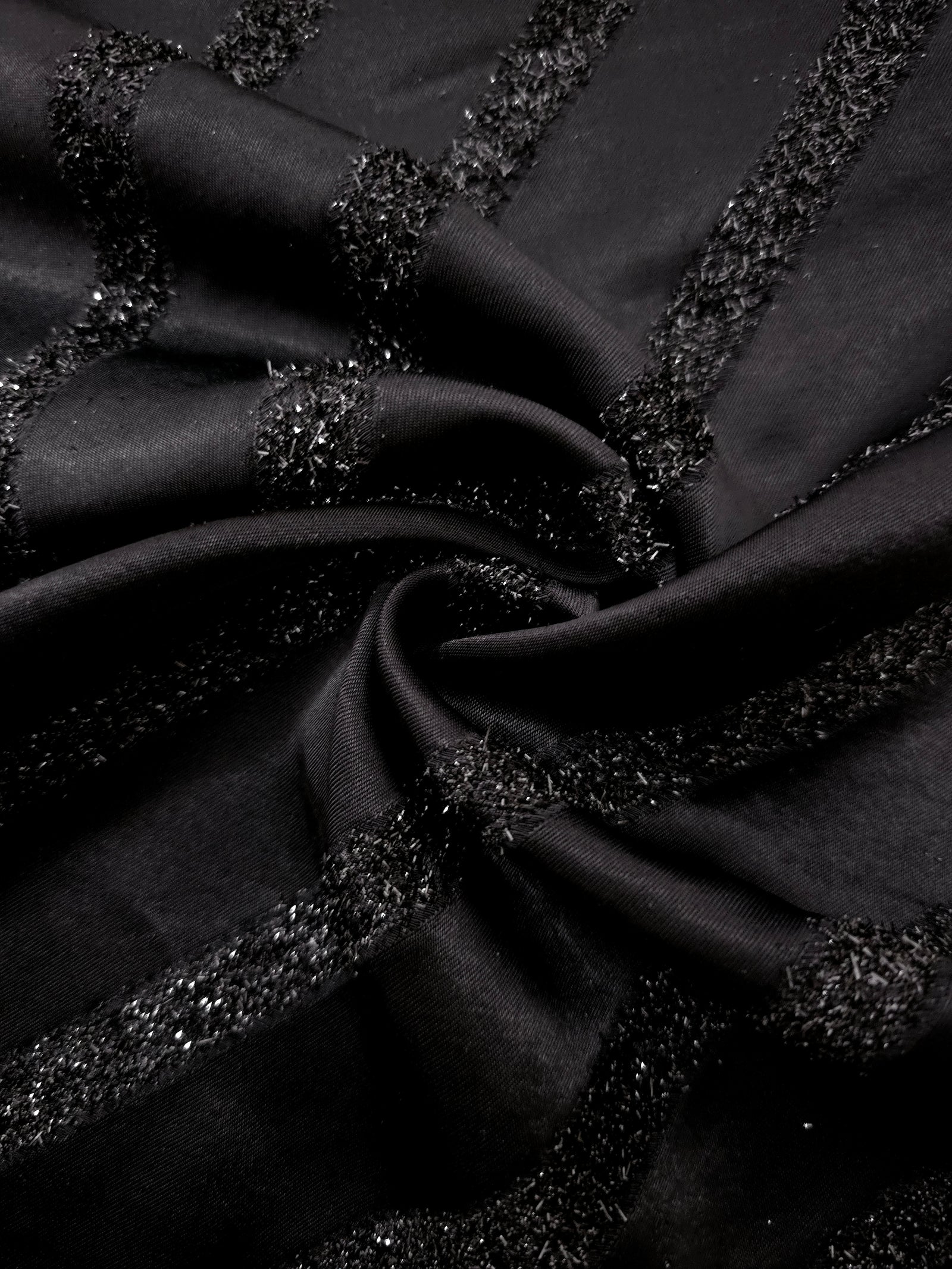 Folded Metallic Black viscose jacquard fabric with slim reflective stripes