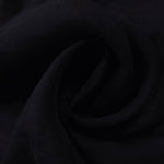 Formal black small leaf embossed viscose jacquard fabric closeup for sheer overlays.