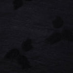 Closeup texture of formal black small leaf embossed viscose jacquard fabric.