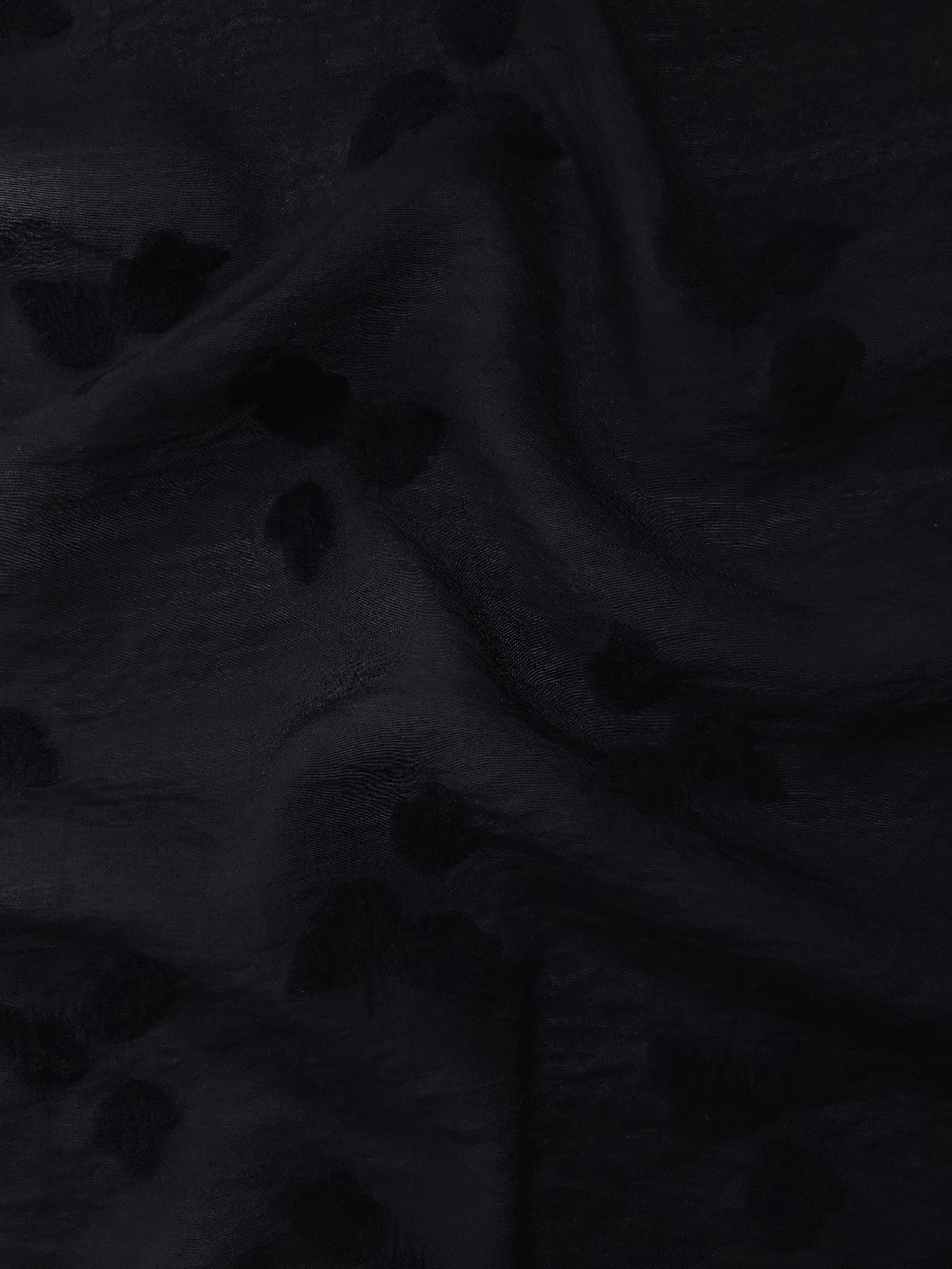 Drape view of formal black small leaf embossed viscose jacquard fabric for garment layers.