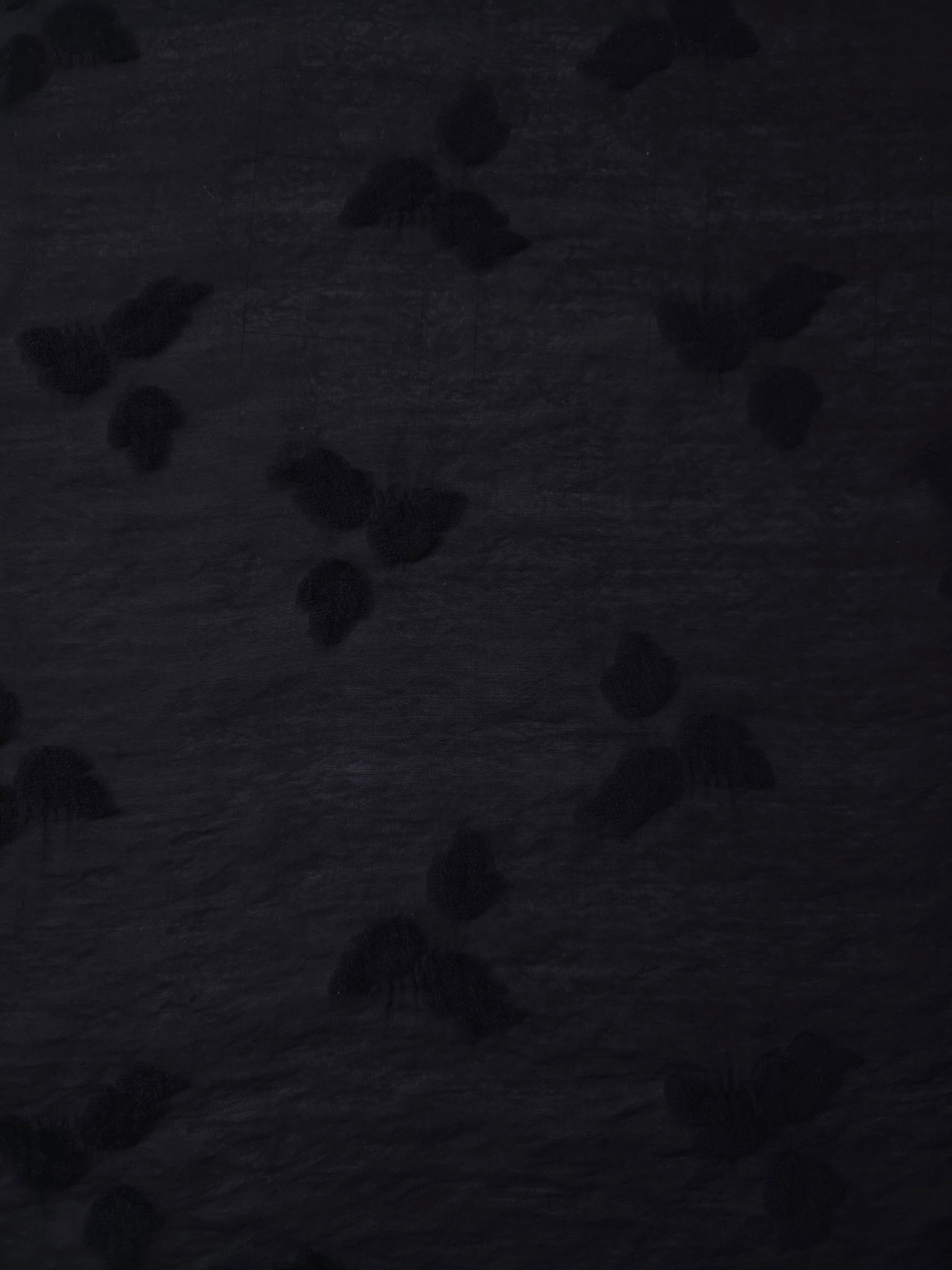 Wide view of formal black small leaf embossed viscose jacquard fabric with raised motif.