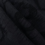 Folded black abstract scroll jacquard fabric for skirts, jackets and occasion pieces.