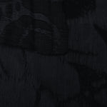Selvage detail of tonal black abstract scroll lyocell viscose jacquard weave.
