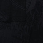 Selvage detail of black arc brushstroke lyocell viscose jacquard fabric.