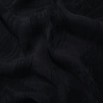 Draped black arc brushstroke jacquard showing movement for blouses and jackets.