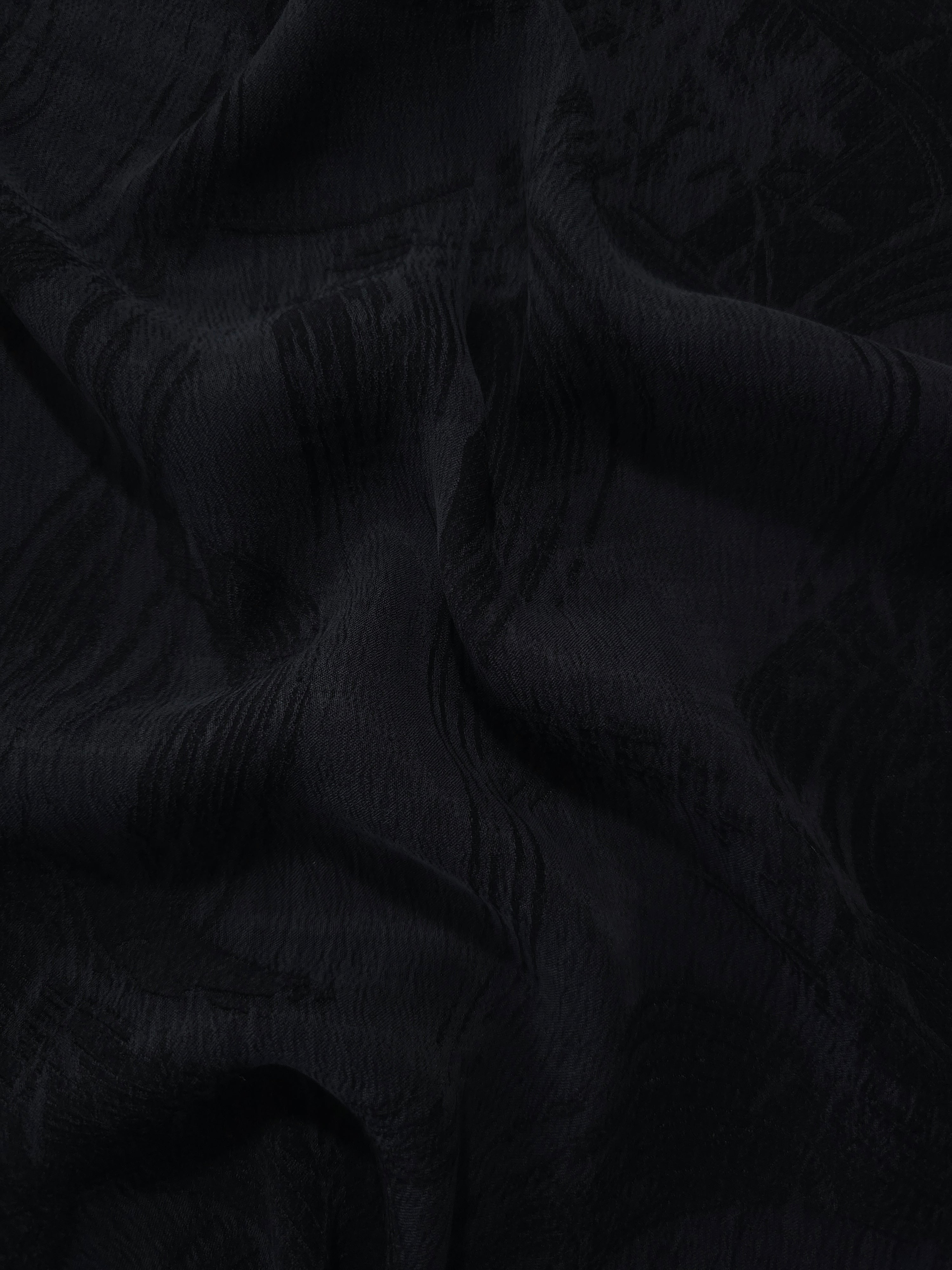 Draped black arc brushstroke jacquard showing movement for blouses and jackets.