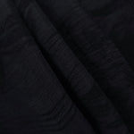 Folded black arc brushstroke lyocell viscose jacquard for tailoring and dress panels.