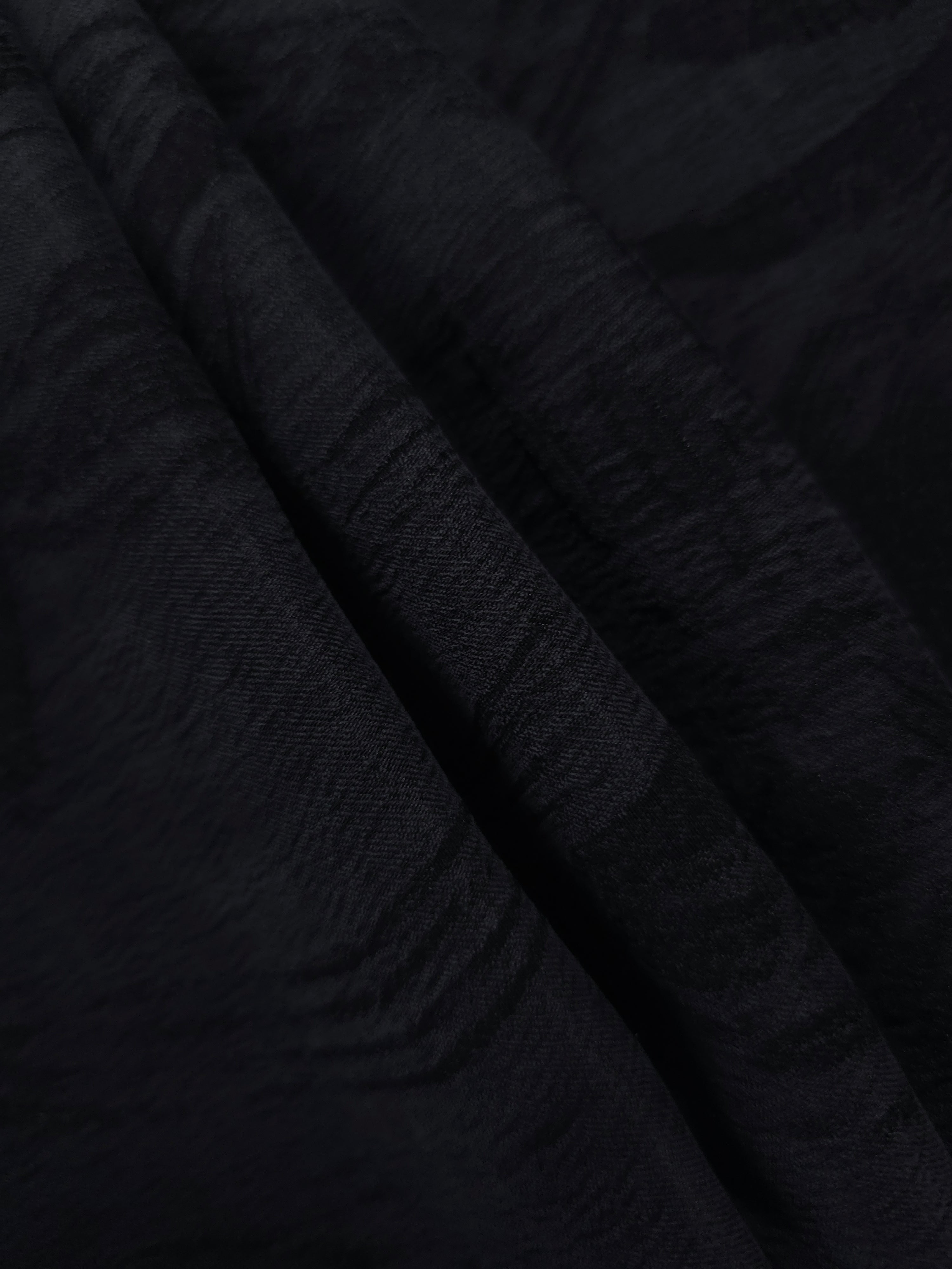 Folded black arc brushstroke lyocell viscose jacquard for tailoring and dress panels.