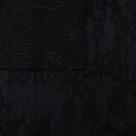 Selvage detail of black botanical floral lyocell viscose jacquard fabric.