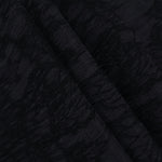 Folded black botanical floral lyocell viscose jacquard for blouses and skirts.