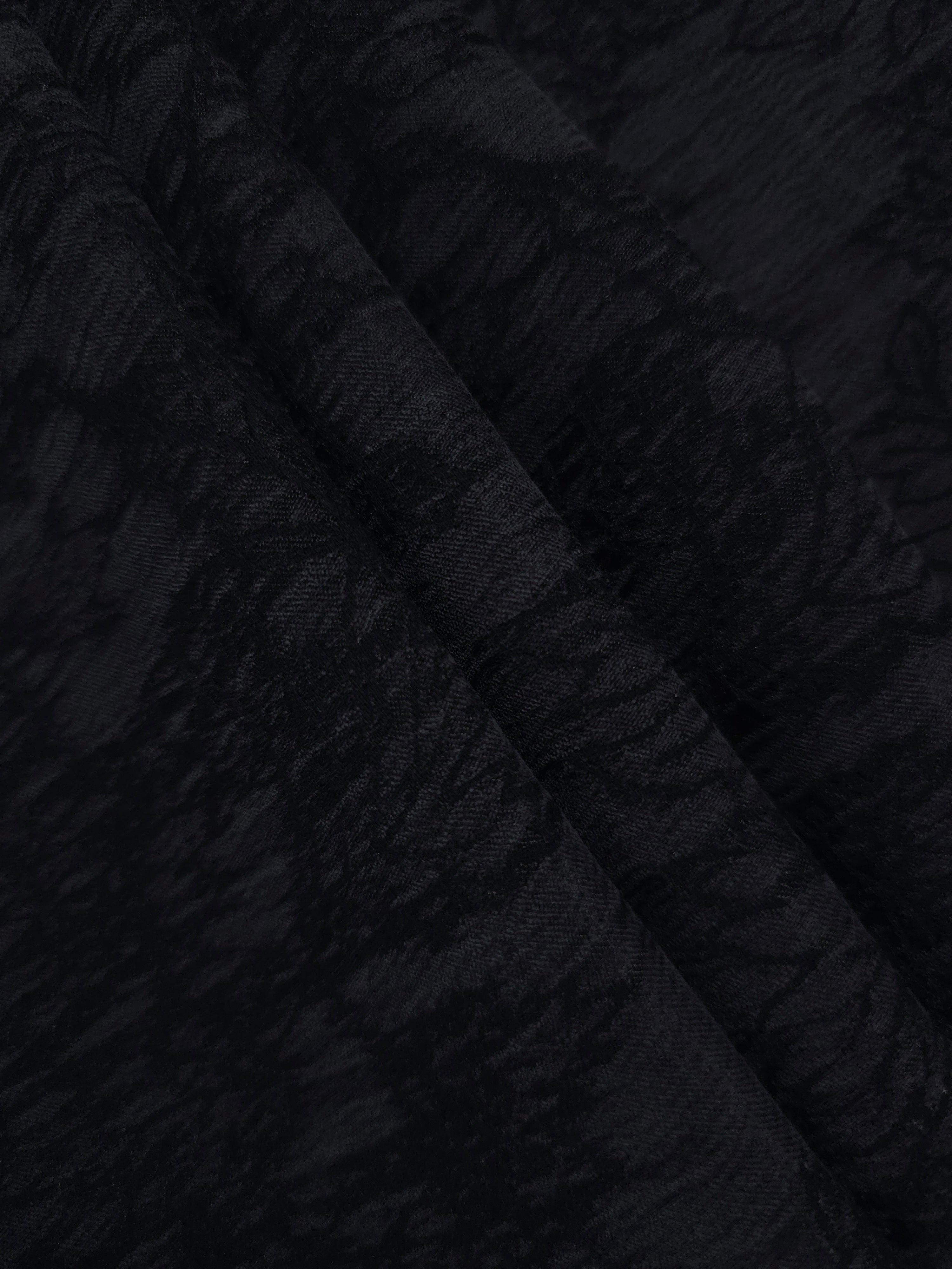 Folded black botanical floral lyocell viscose jacquard for blouses and skirts.