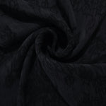 Swirl drape of black botanical floral jacquard with darker floral surface contrast.