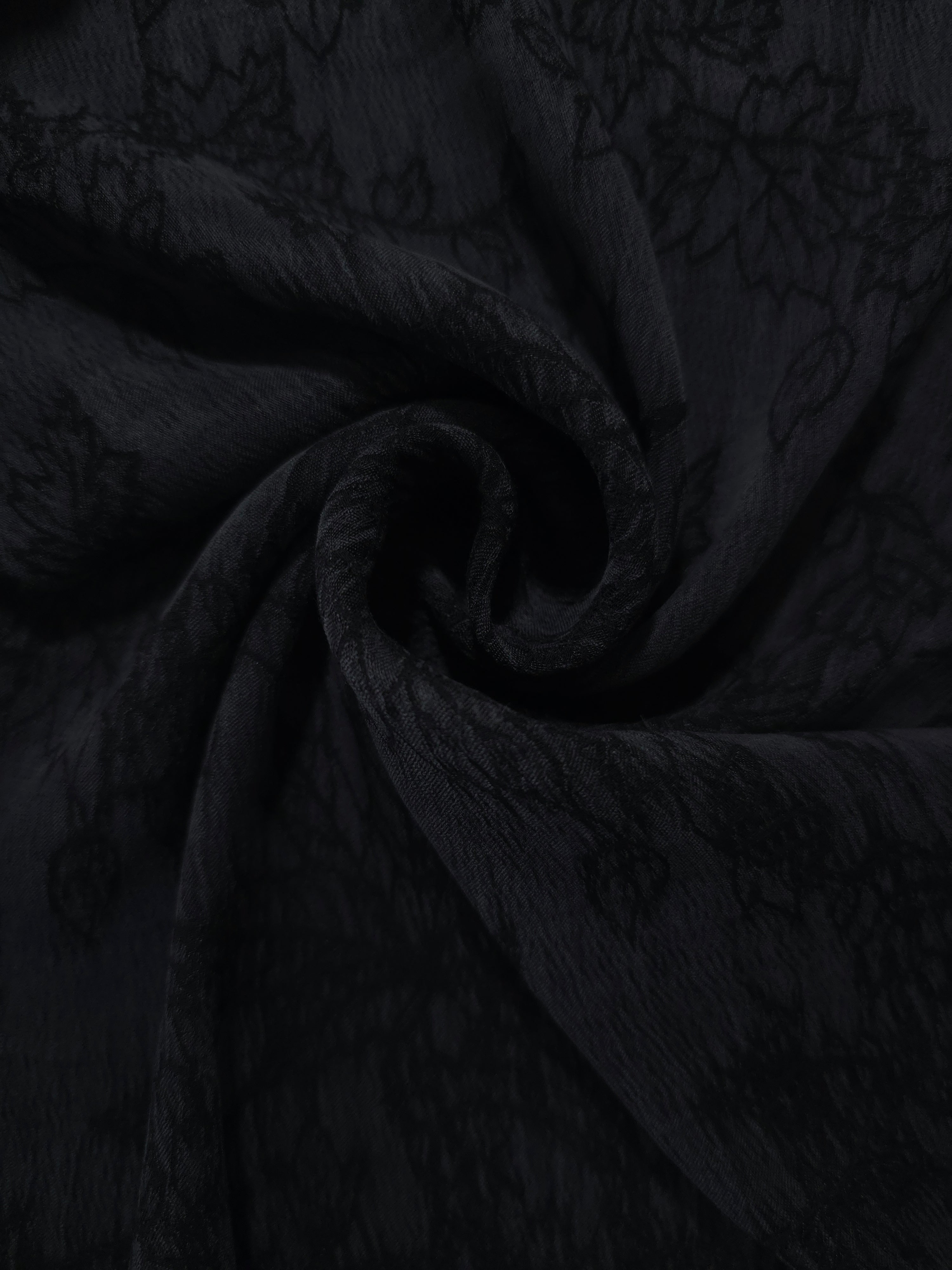 Swirl drape of black botanical floral jacquard with darker floral surface contrast.