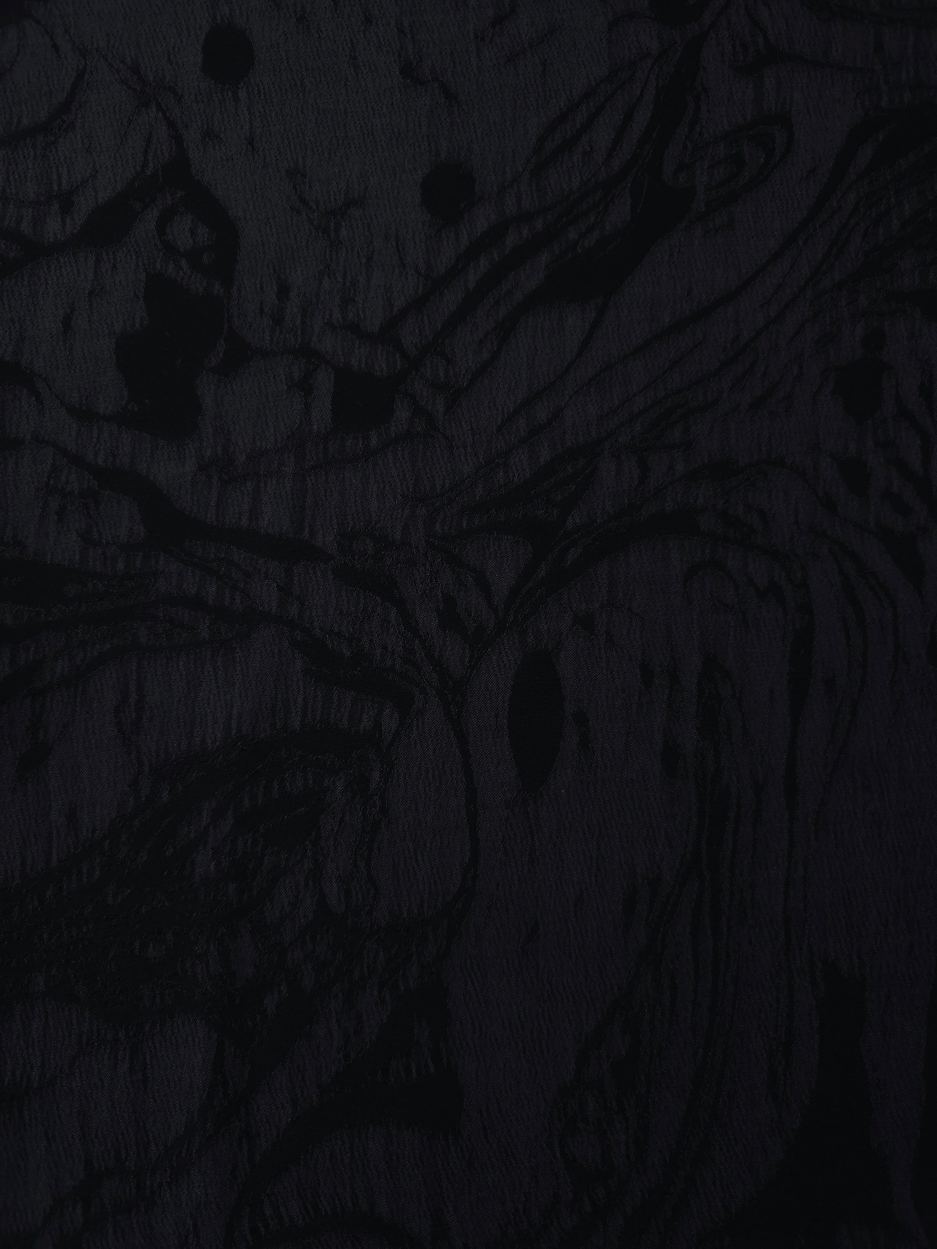 Black botanical scroll lyocell viscose jacquard with tonal vine texture for dresses.