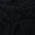 Close texture of black botanical scroll jacquard showing raised woven detail.
