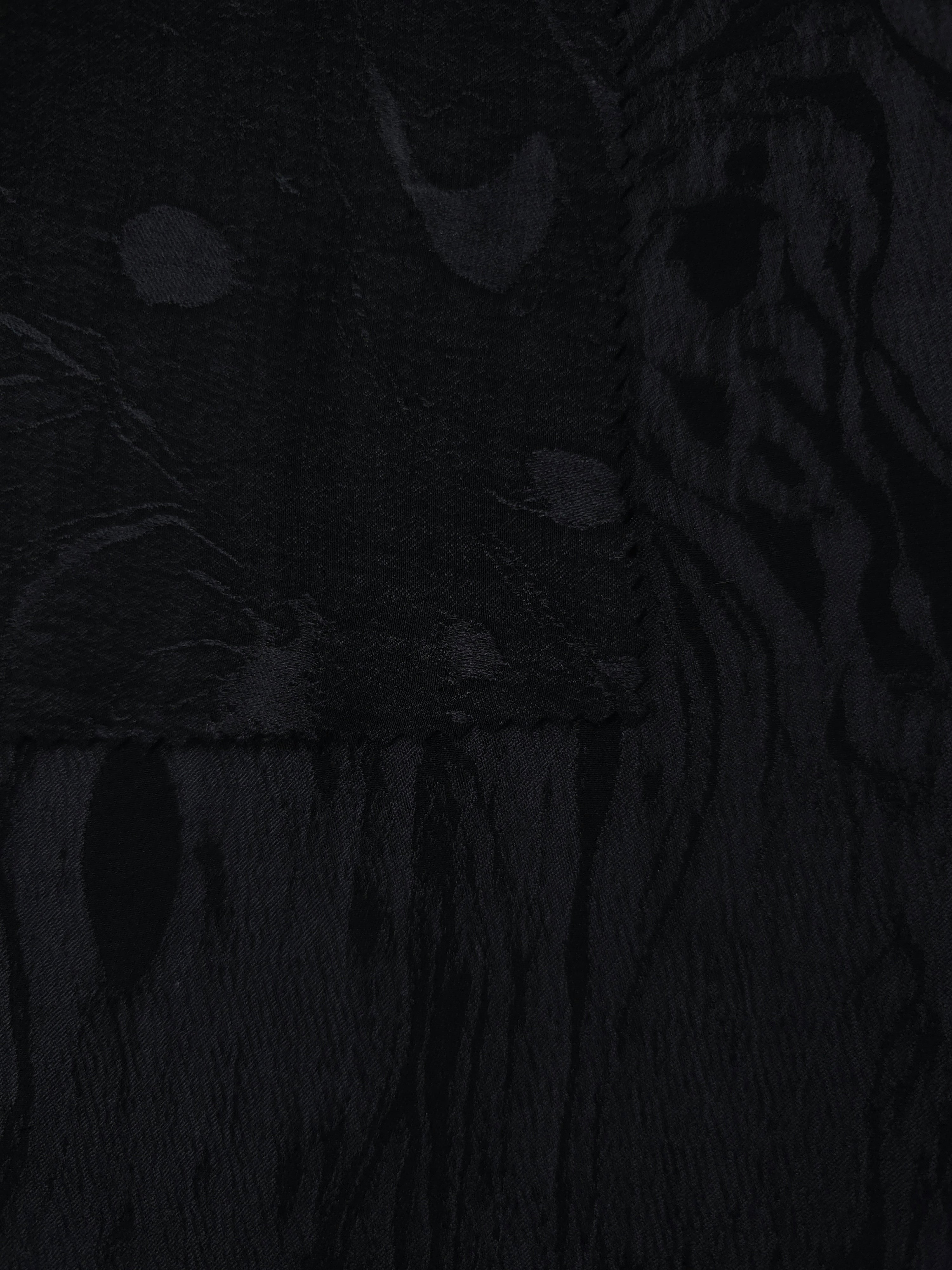 Selvage detail of black botanical scroll lyocell viscose jacquard for matching edges.