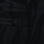 Selvage detail of black brushstroke leaf lyocell viscose jacquard for fabric matching.
