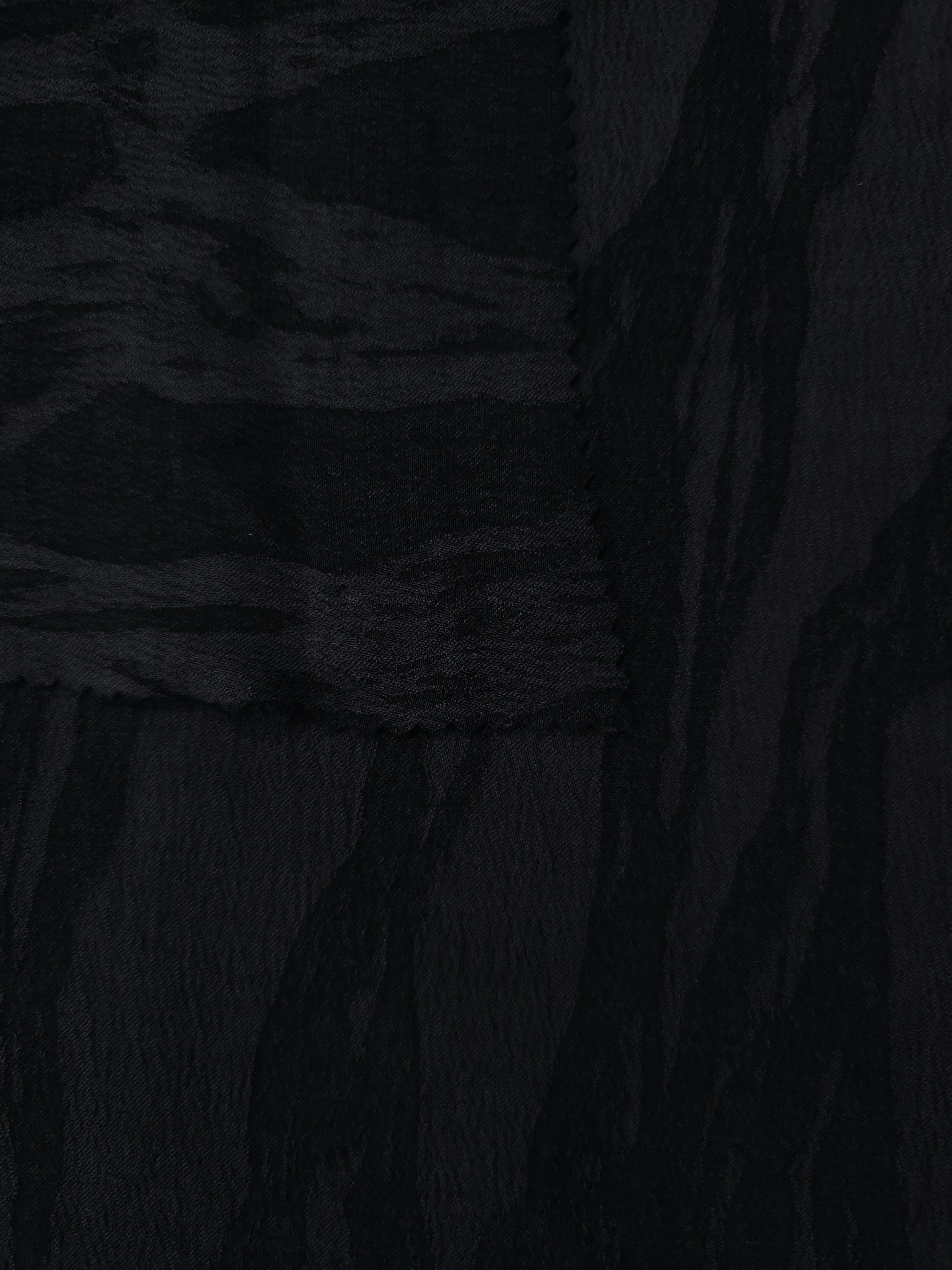 Selvage detail of black brushstroke leaf lyocell viscose jacquard for fabric matching.